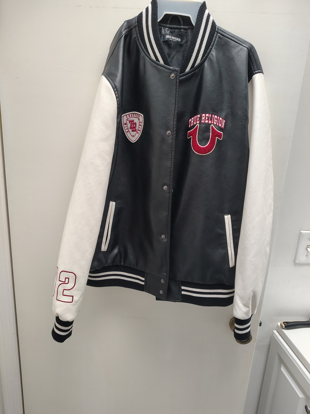 True Religion Black Leather Varsity Jacket with White Sleeves and Red Accents